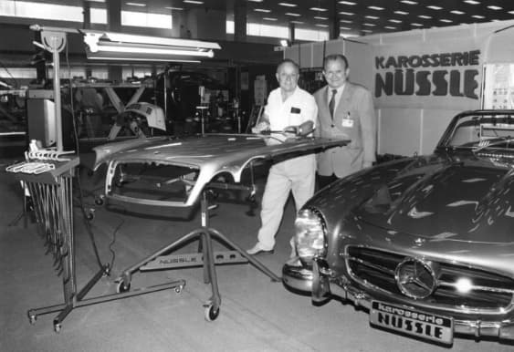 Oskar Flaig working on Mercedes Benz at what looks like the MOtor Sports trade show